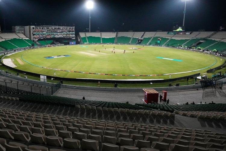 A cricket fielder diving to make a spectacular catch as fans watch in excitement, reflecting the growing appreciation of fielding skills.
