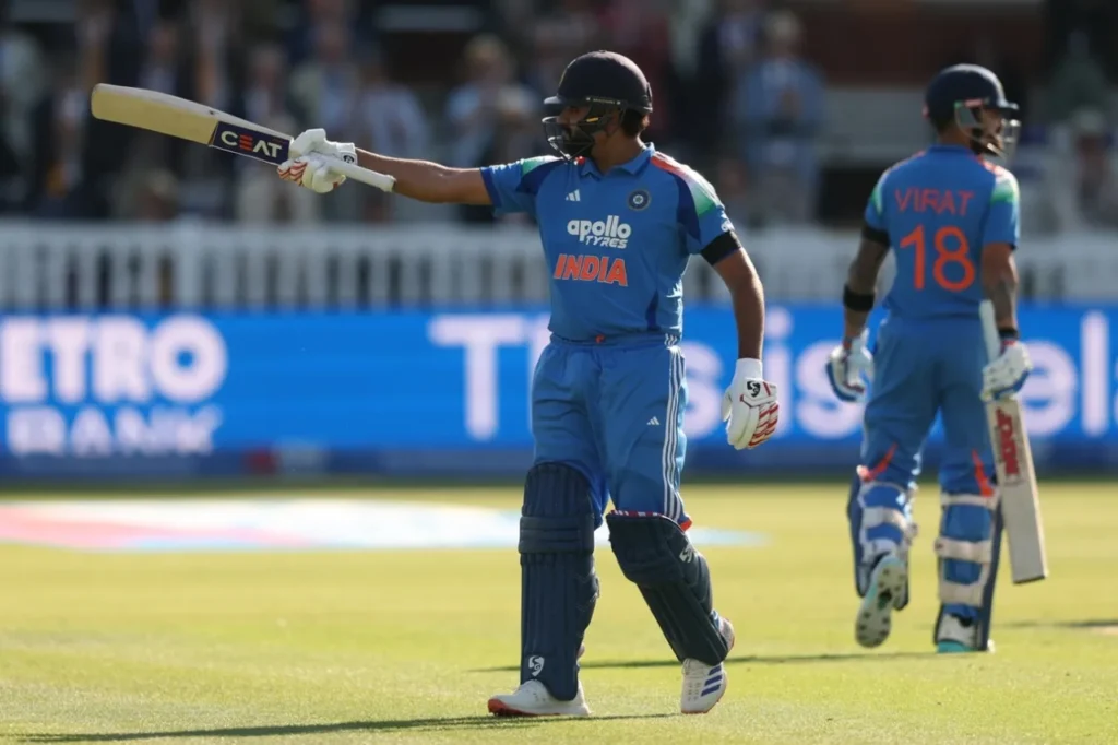 Rohit Sharma in India's blue cricket jersey looking determined under dramatic stadium lights, symbolizing his remarkable comeback after scoring a match-defining century and silencing retirement critics.