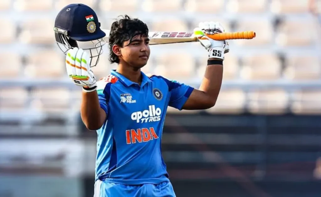 Vaibhav Sooryavanshi celebrates after breaking a historic cricket record, raising his bat in a packed international stadium under dramatic lights, symbolizing the rise of India's youngest cricket sensation.
